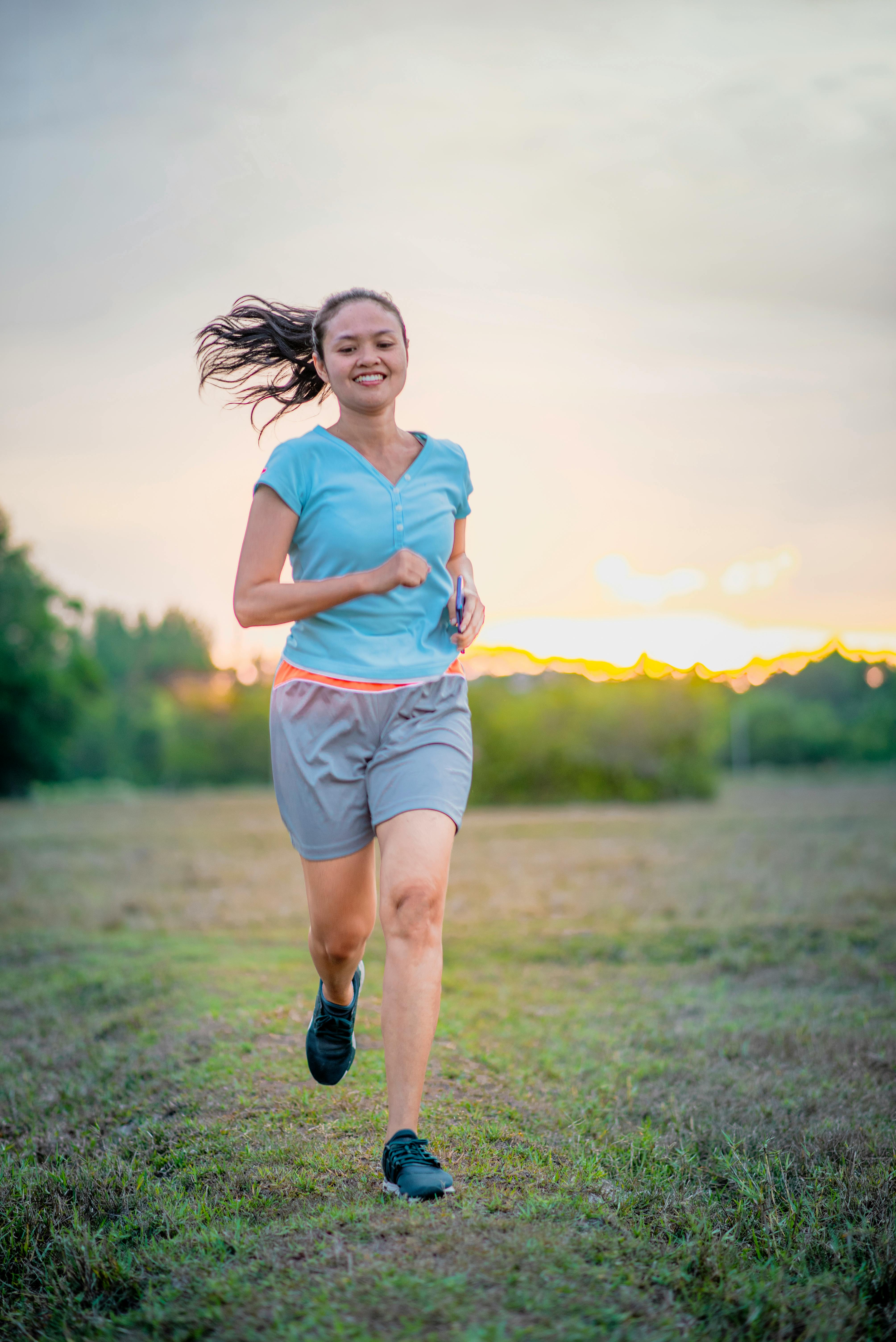 Woman running outdoors at sunset